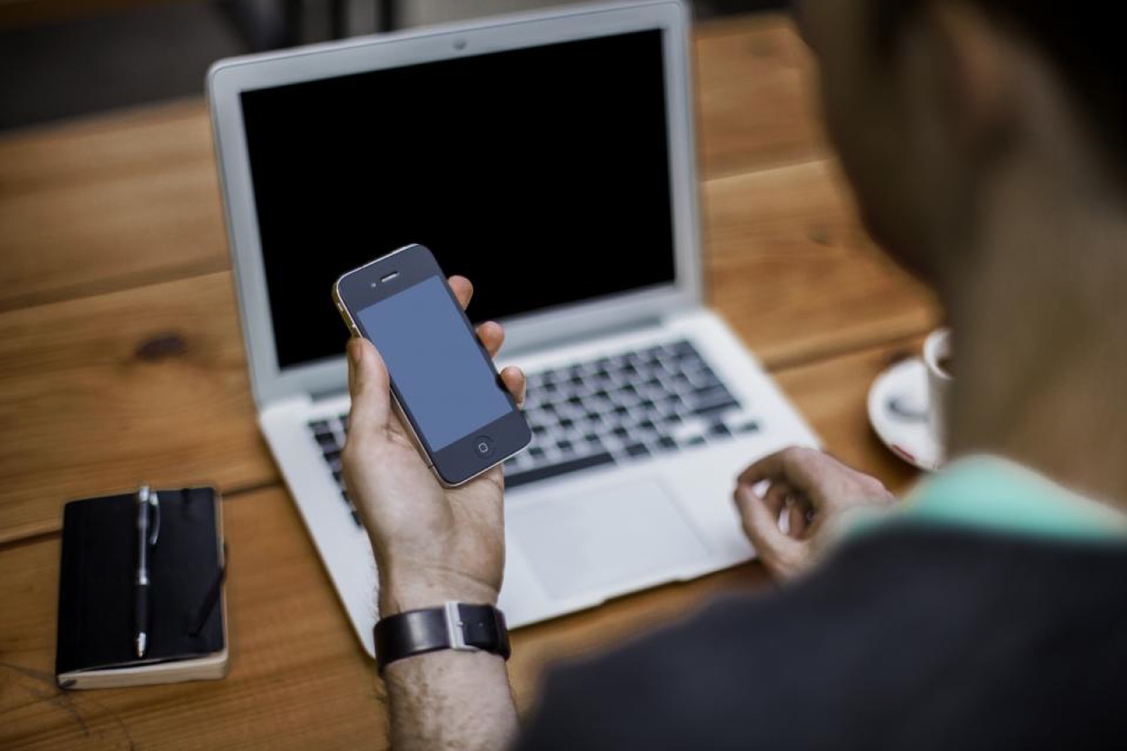 Homeowner checking a phone message, a reminder to verify wiring instructions and avoid cash home buyer scams