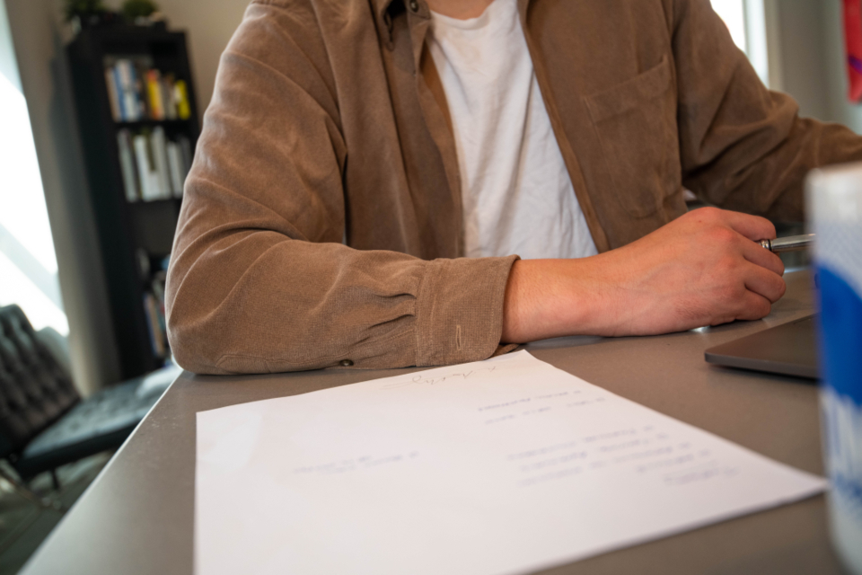 Home seller reviewing a closing statement at a desk